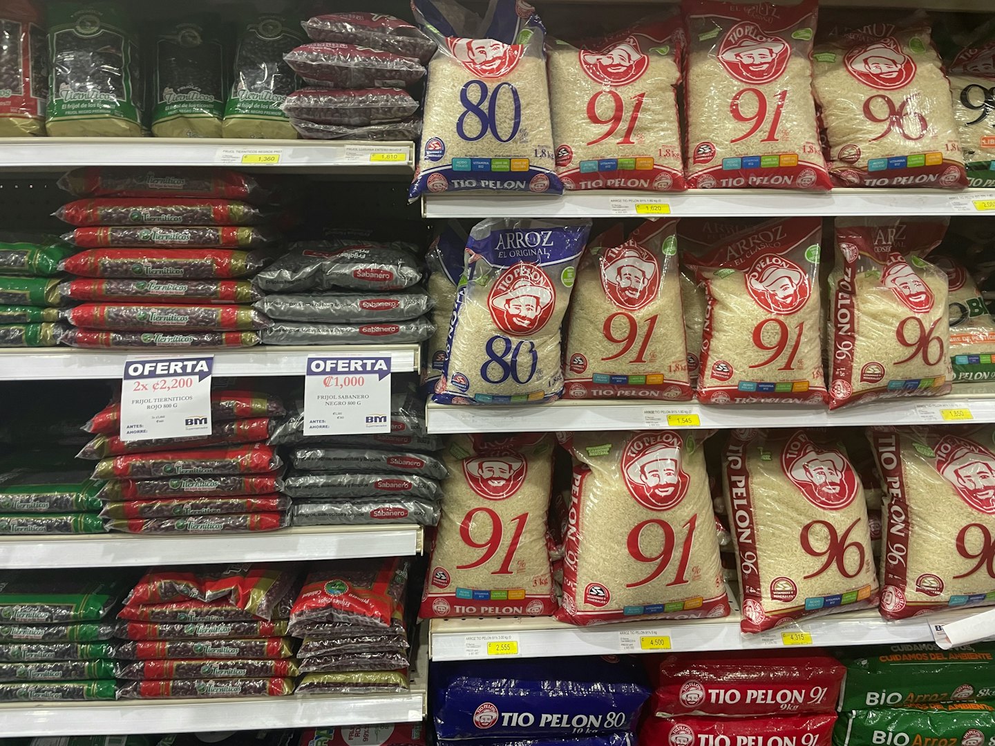 Grocery store aisle with shelves stocked with rice and beans.